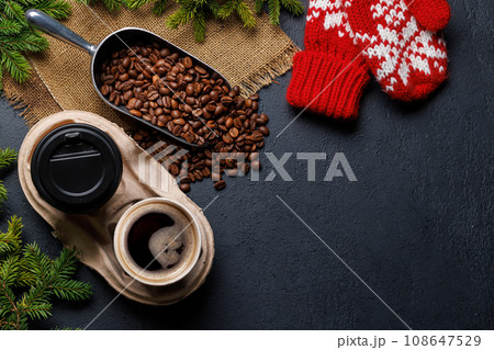 Coffee cup and fir tree branches in cozy setting Coffee cup and fir tree branches in cozy setting 108647529