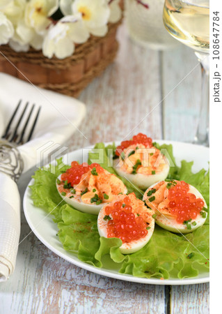 Stuffed eggs with salmon caviar Stuffed eggs with salmon caviar 108647784