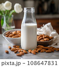Almond milk in bottle with nuts. Non Dairy milk substitute drink, healthy eating. 108647831