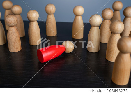 A red man lying in a faint, wooden figurine. Could not stand the load and hardships of work. Working hard. Health problems. Burnout at work. Weak link. Out of order. 108648275