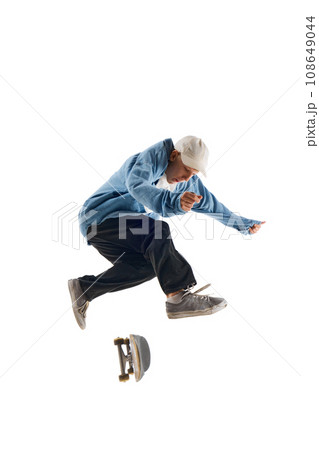 Dynamic image of sportive young man in casual clothes in motion, raining, jumping with skateboard isolated over white background Dynamic image of sportive young man in casual clothes in motion, raining, jumping with skateboard isolated over white background 108649044
