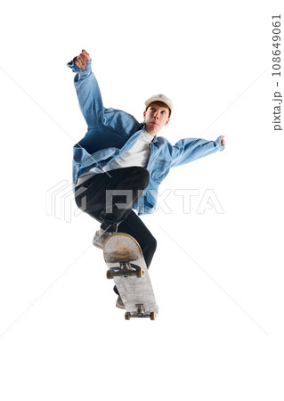 Sportive, active young man in casual clothes in motion, training with skateboard, doing stunts isolated over white background 108649061
