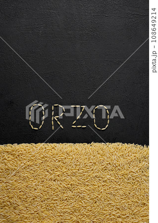 Italian pasta orzo on a black background, top view. Close-up of hard pasta in the shape of small rice. 108649214
