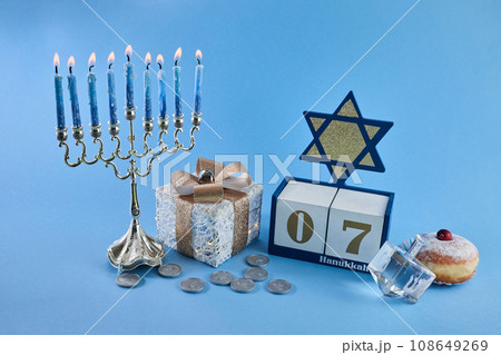 Jewish holiday Hanukkah with menorah, traditional Candelabra, donut and dreidel, spinning top. 108649269