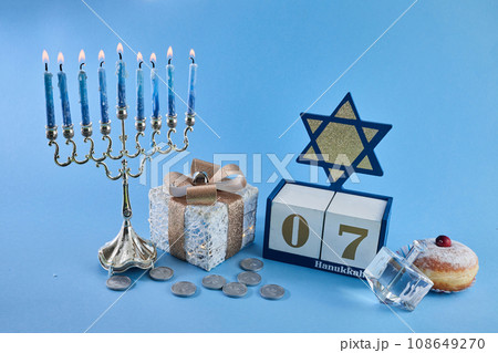 Jewish holiday Hanukkah with menorah, traditional Candelabra, donut and dreidel, spinning top. 108649270