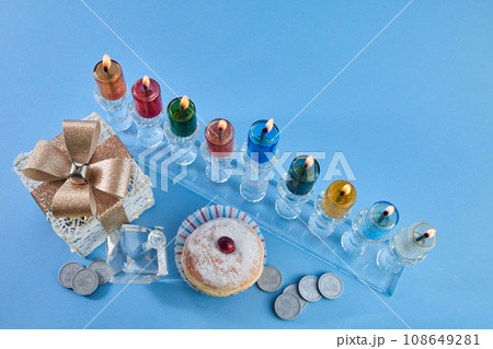 Jewish holiday Hanukkah with menorah, traditional Candelabra, donut and dreidel, spinning top. 108649281