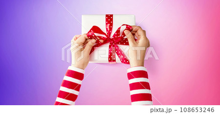 Person making a Christmas gift box 108653246