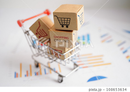 Online shopping, Shopping cart box on business graph, import export, finance commerce. Online shopping, Shopping cart box on business graph, import export, finance commerce. 108653634