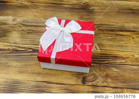 Gift box on a wooden background Gift box on a wooden background 108656776