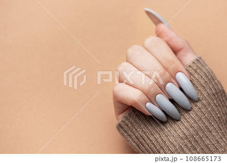 Woman's hand with grey nail polish Woman's hand with grey nail polish 108665173
