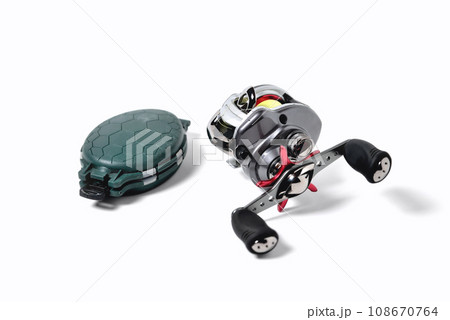 fishing reel and box for accessories on a white background, close-up 108670764