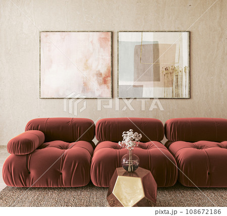 Abstract art above plush red sofas in chic interior 108672186