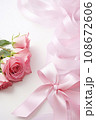 pink rose with ribbon and bow on white background, closeup 108672606