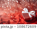 Gift box on red satin background with bokeh 108672609