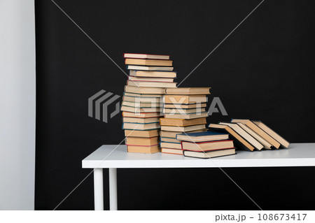 stack of books on a black background science education culture training 108673417
