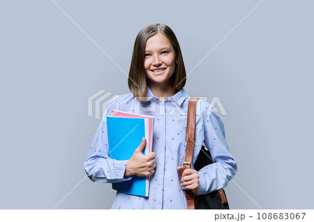 Portrait of young university female student on gray background Portrait of young university female student on gray background 108683067