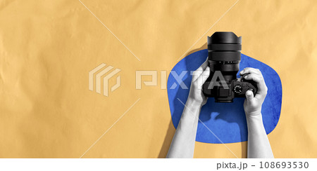Person holding a SLR camera Person holding a SLR camera 108693530