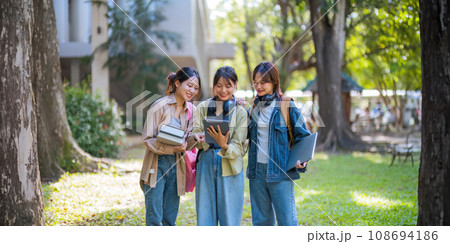 Student university friendship concept with classmate walking together at campus college park. Youth teenage and education Student university friendship concept with classmate walking together at campus college park. Youth teenage and education 108694186