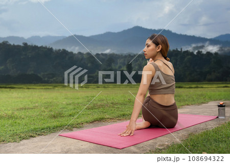 Asian woman sporty practicing yoga at public park outdoor stretching her body. Healthy active lifestyle Asian woman sporty practicing yoga at public park outdoor stretching her body. Healthy active lifestyle 108694322