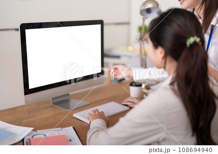 Computer mock up. Two business people discussion in office with visible white empty screen with copy space 108694940