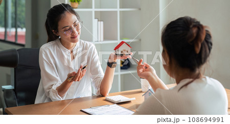 Real estate agent to his discussion and consult about house contracts client after signing contract, concept for real estate, moving home or renting property Real estate agent to his discussion and consult about house contracts client after signing contract, concept for real estate, moving home or renting property 108694991