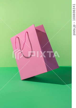 Paper shopping bag on green background. Paper shopping bag on green background. 108696341
