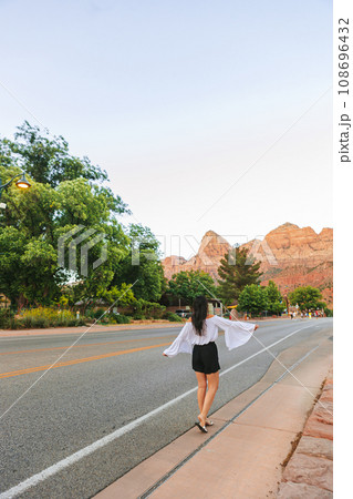 Young hiker woman in Springdale is a quaint town at the entrance of Zion National Park 108696432