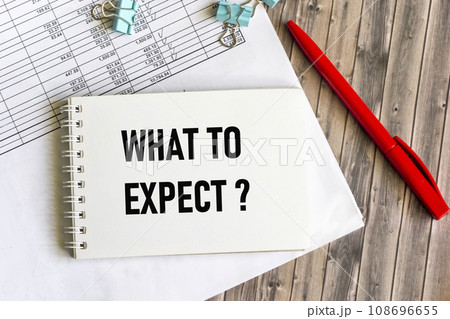On the table there is a pen, charts and a notepad with the inscription - WHAT TO EXPECT. 108696655