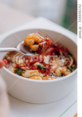 Appetizing Thai food of pumpkin porridge with shrimps served with greens and seeds in restaurant Appetizing Thai food of pumpkin porridge with shrimps served with greens and seeds in restaurant 108698142