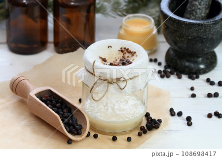 Alternative medicine, filtering juniper  ointment 108698417