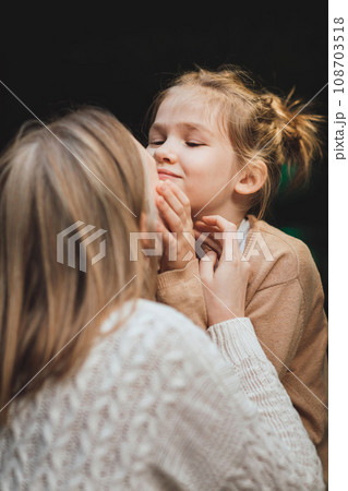 mum and teenage daughter having fun on a walk in the city.  108703518