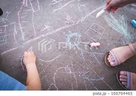 Children draw with chalk on the road. Children's creativity on the street. Children draw with chalk on the road. Children's creativity on the street. 108704465