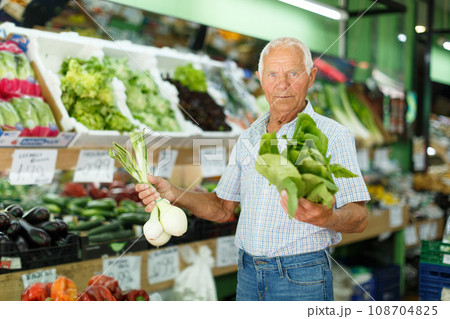 Elderly man looking for fresh vegetables Elderly man looking for fresh vegetables 108704825