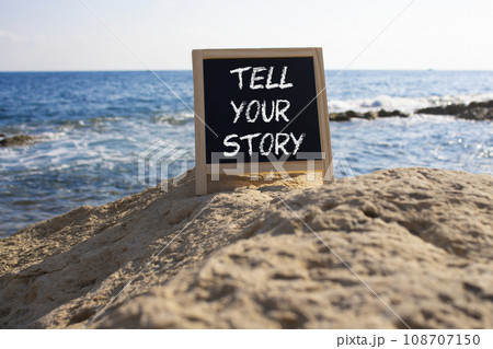 Tell your story symbol. Concept words Tell your story on black chalk blackboard. Beautiful sea background. Business and Tell your story concept. Copy space. Tell your story symbol. Concept words Tell your story on black chalk blackboard. Beautiful sea background. Business and Tell your story concept. Copy space. 108707150
