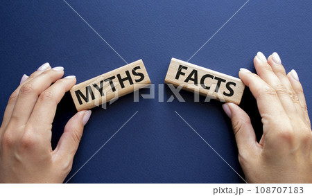 Facts or Myths symbol. Concept word Facts or Myths on wooden blocks. Businessman hand. Beautiful deep blue background. Business and Facts or Myths concept. Copy space 108707183