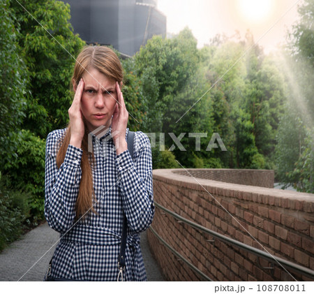 Girl with a headache on the street Girl with a headache on the street 108708011