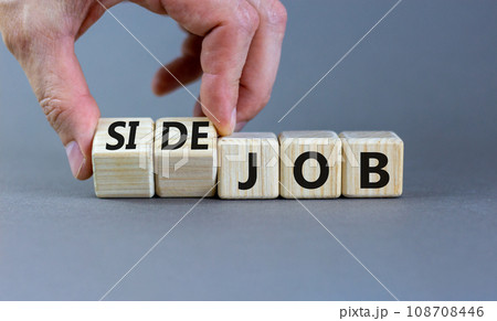 Side job symbol. Businessman turns wooden cubes and changes concept words Job to Side job. Beautiful grey table grey background, copy space. Business side job concept. 108708446