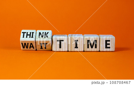Think or wait time symbol. Turned wooden cubes and changed words 'wait time' to 'think time'. Beautiful orange background, copy space. Business and think or wait time concept. 108708467