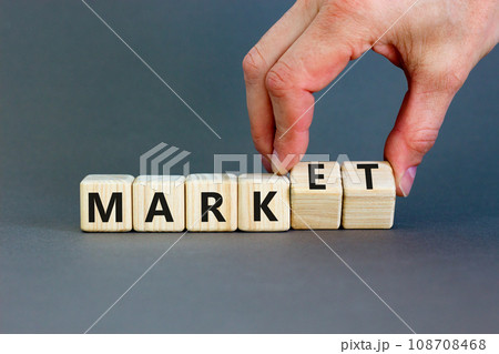 Mark of market symbol. Businessman turns wooden cubes and changes word Mark to Market. Beautiful grey table grey background. Business mark of market concept. Copy space. 108708468