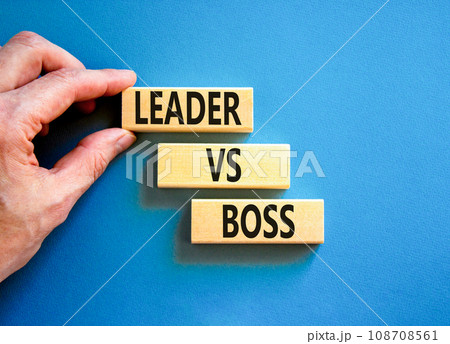 Boss vs leader symbol. Concept words Boss vs versus leader on wooden block. Beautiful blue table blue background. Businessman hand. Business motivational boss vs leader concept. Copy space. 108708561