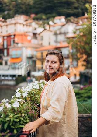 Happy brunette 30s woman enjoying summer holidays. Concept of vacation and travelling. Varenna, Italy. Lake Como 108709252