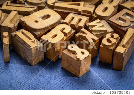 random letterpress wood type printing blocks against handmade textured paper 108709505