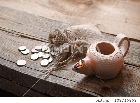 Pouch with silver coins on a wooden table Pouch with silver coins on a wooden table 108710808