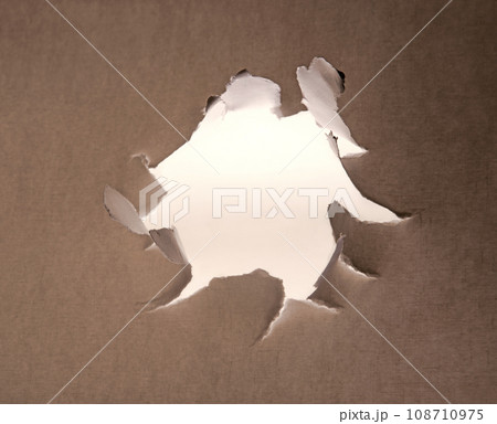 Hole punched in a paper sheet Hole punched in a paper sheet 108710975
