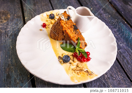 a piece of sponge cake on a plate. dessert in the restaurant photo for the menu 108711015