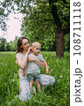 Young woman mom and son play in nature, spend time together and have fun 108711118