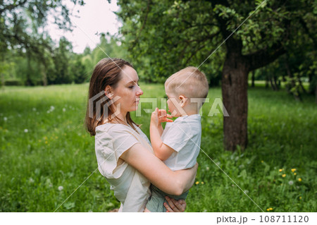 Young woman mom and son play in nature, spend time together and have fun 108711120