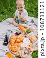 Boy child preschooler on a picnic. Smiles, eating cherries and enjoying summer. 108711121