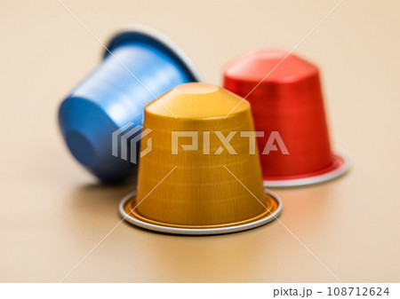 Fresh aroma natural organic coffee aluminium capsules pods on beige background.Macro 108712624