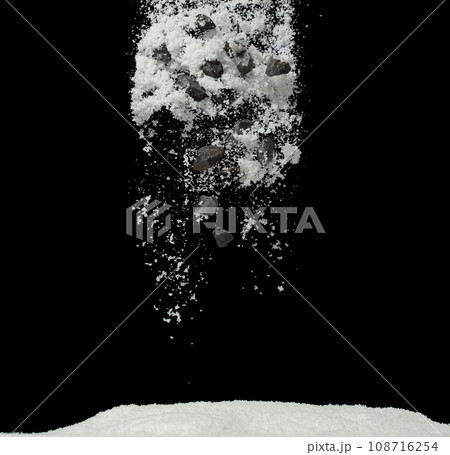 Rock stone construction object under snow on roof. Dangerous rock stone object hidden in snow. Snow fall with risk accident hazard cover trash garbage debris. Black background isolated 108716254